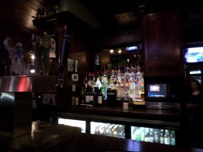 The bar at Capital Pub. Darts are behind the bar.