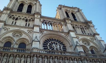 Notre Dame during the day. The intricate work above the front entrance.  