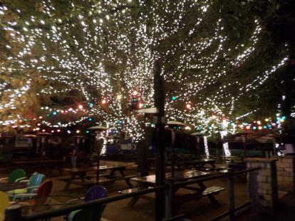 The patio with tree lights during the night at Katy Trail Ice House. 