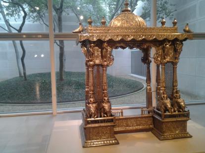 Atrium with trees. Shrine made from silver over wood from India.