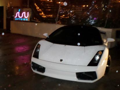 White Lamborghini parked outside Susu